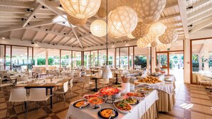 A spacious dining area with multiple tables, a buffet setup, and hanging paper lanterns. - Le Dune Beach Club (Messina)