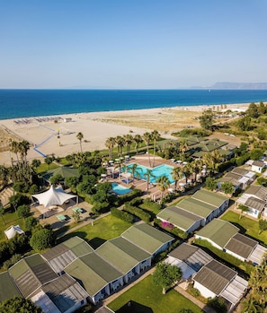 A resort with multiple bungalow-style accommodations, a central swimming pool, and a beach area. - Le Dune Beach Club (Messina)