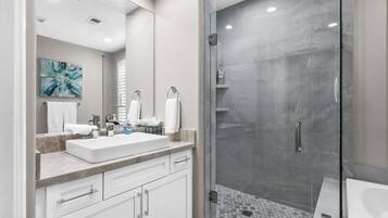 Bathtub, hair dryer, towels, toilet paper