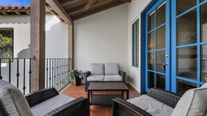 A covered patio with wicker furniture, a ceiling fan, and a potted plant. - Have Fun and Relax at Luxury Legacy Villa. Family Friendly or Great for Couples! (La Quinta)