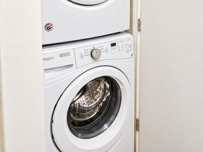 A front view of a white Whirlpool washing machine with a control panel and a front-loading door. - Northwest Nob Hill 97 walk score! Free Parking! 600 sq.ft. (Portland)