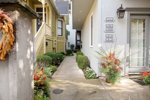 A narrow pathway flanked by buildings with numbered signs, suggesting a historical or heritage site.