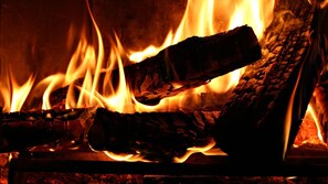Ein Nahblick auf brennende Holzscheite im Kamin.