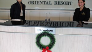 A reception desk at Suvarnabhumi Oriental Resort with a sign indicating it is the reception area. - Suvarnabhumi Oriental Resort (Bangkok)