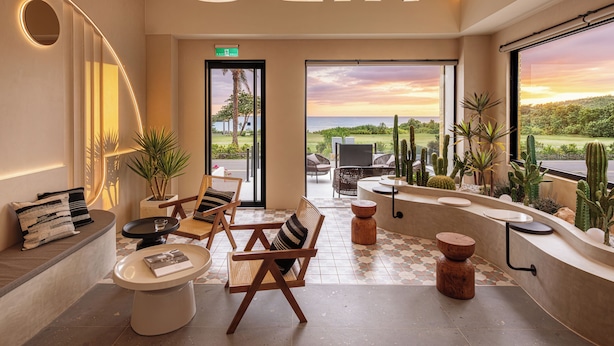 A modern interior with a seating area, a reception desk, and a view of the outdoors. - Hido Hotel II (Hengchun)