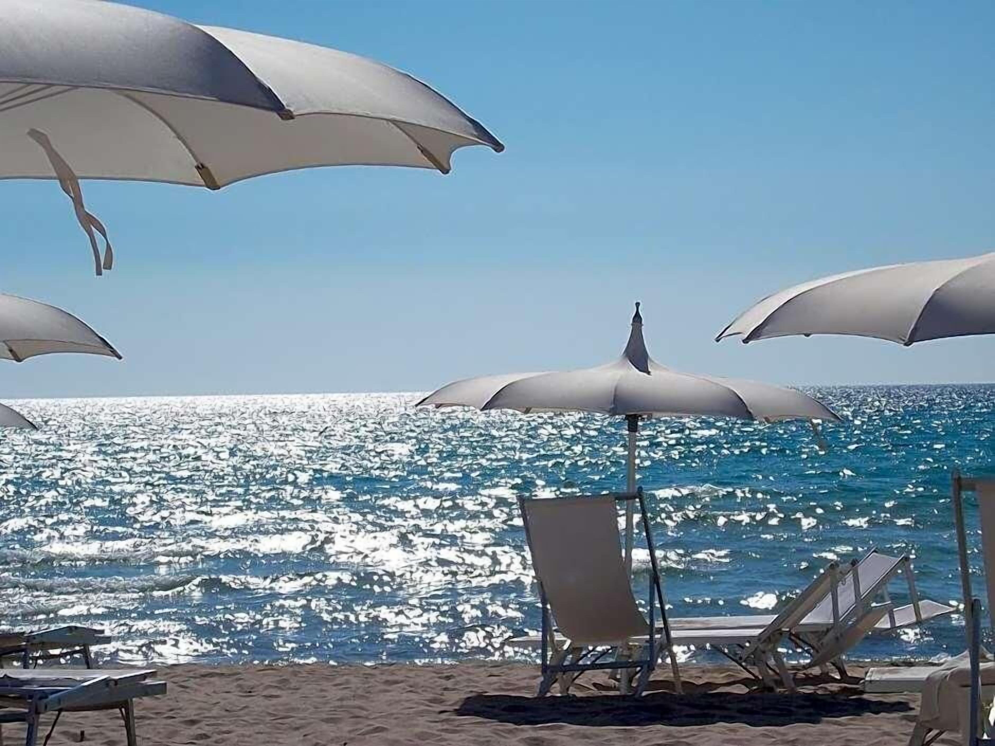 Private beach, white sand, sun loungers, beach umbrellas