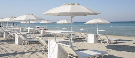 Private beach, white sand, sun loungers, beach umbrellas