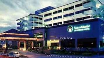 A multi-story hotel with a prominent sign reading "R24.00".