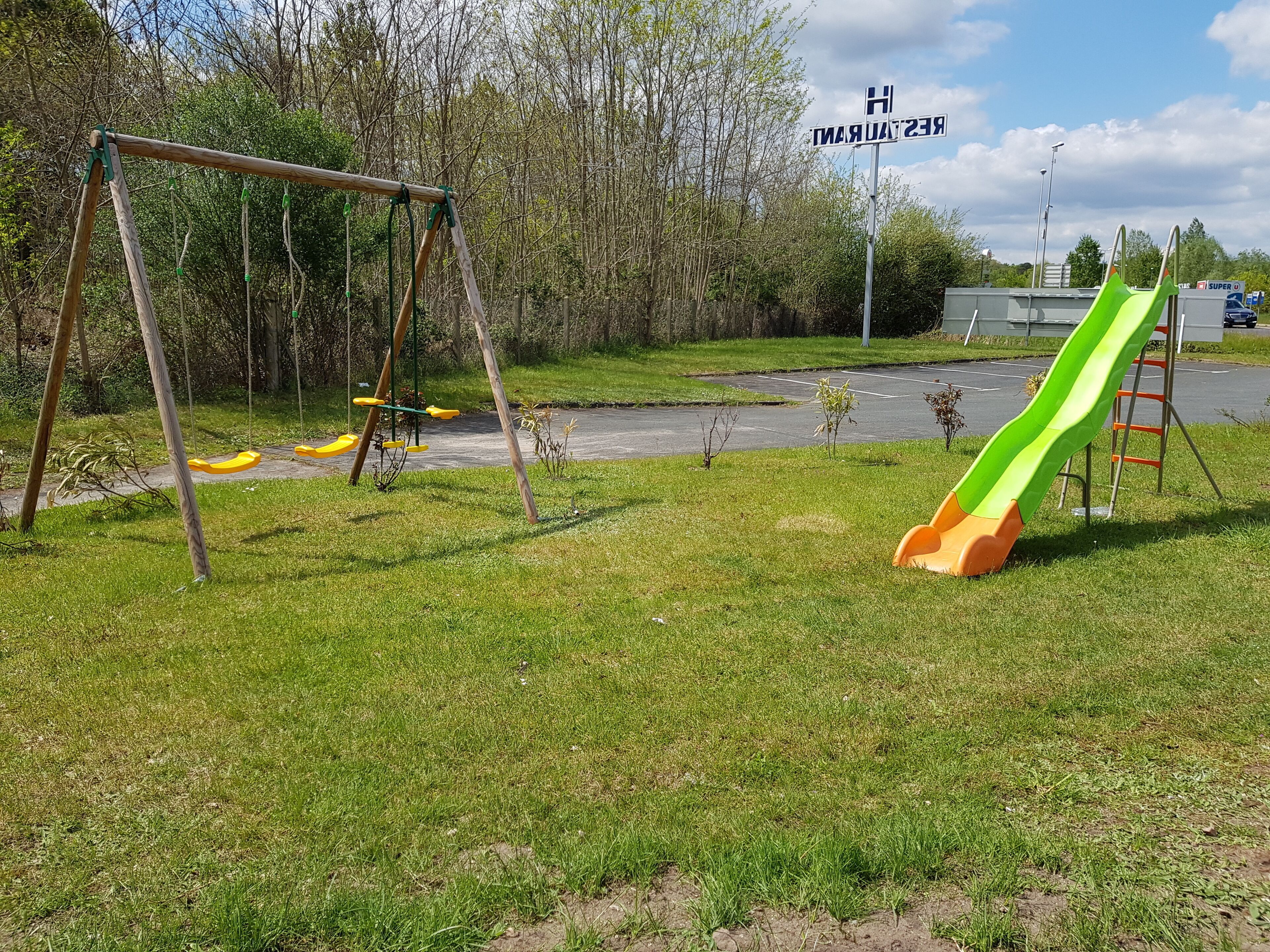 A playground with a swing set and a slide.