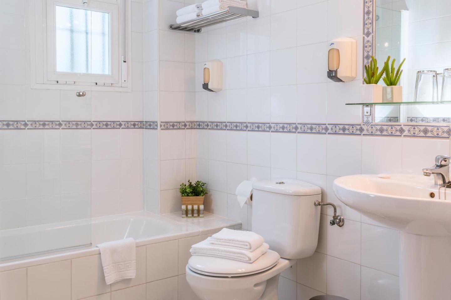 A modern bathroom with a bathtub, toilet, and sink.