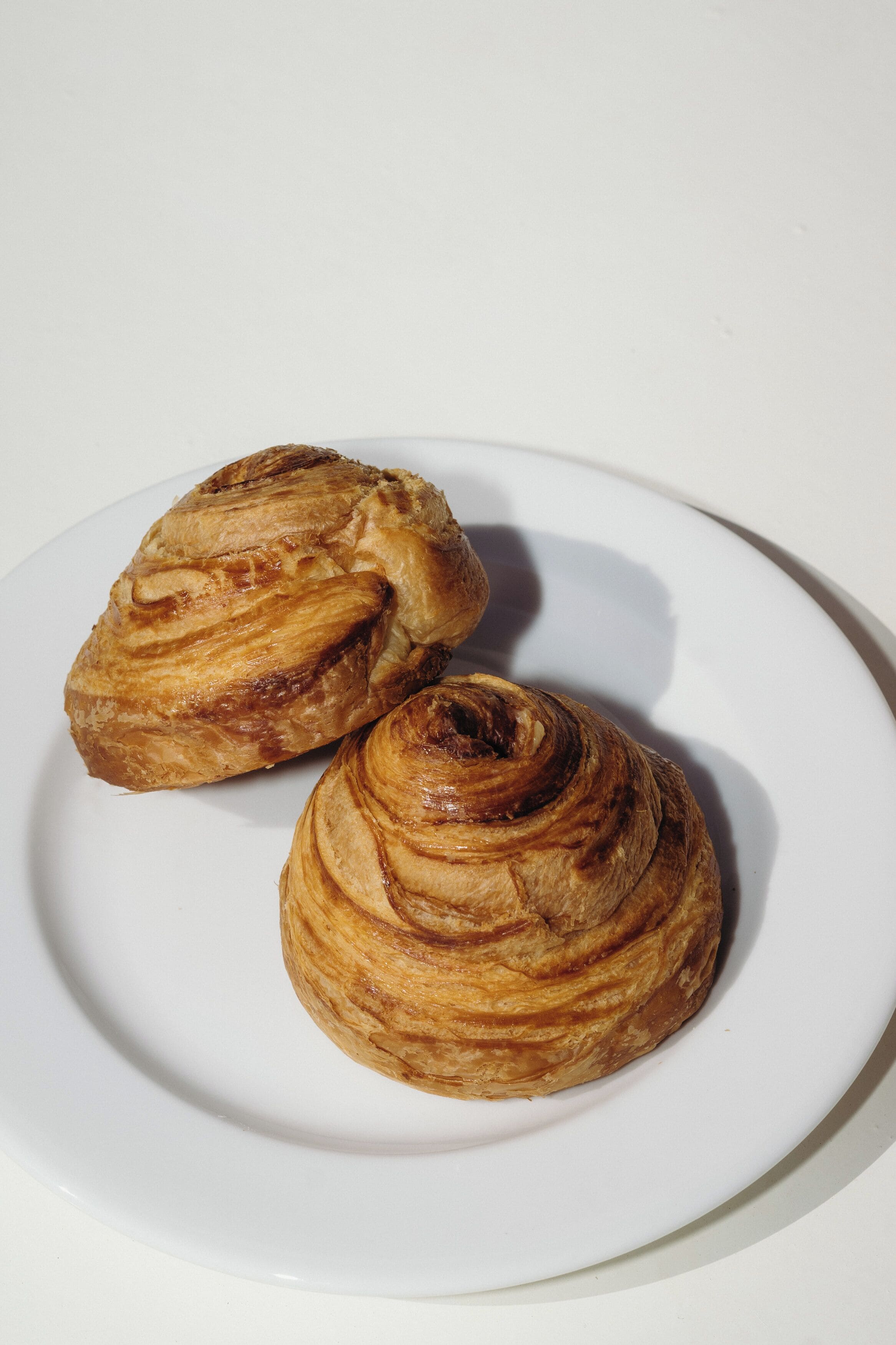 Two pastries on a white plate.