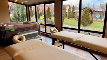 Experience rejuvenation with two massage therapy tables, one featuring a heating function.