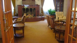 A traditional room with a fireplace, wooden furniture, and a large cabinet. - Naeba Springs Hotel (Yuzawa)