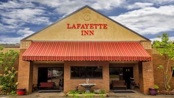 Step under the charming entrance awning and into the Lafayette Inn, where a large window above the door and a small fountain create a welcoming atmosphere.