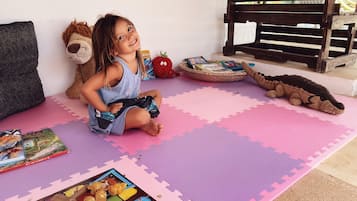 Children can play and learn in this cozy space, surrounded by toys and books.