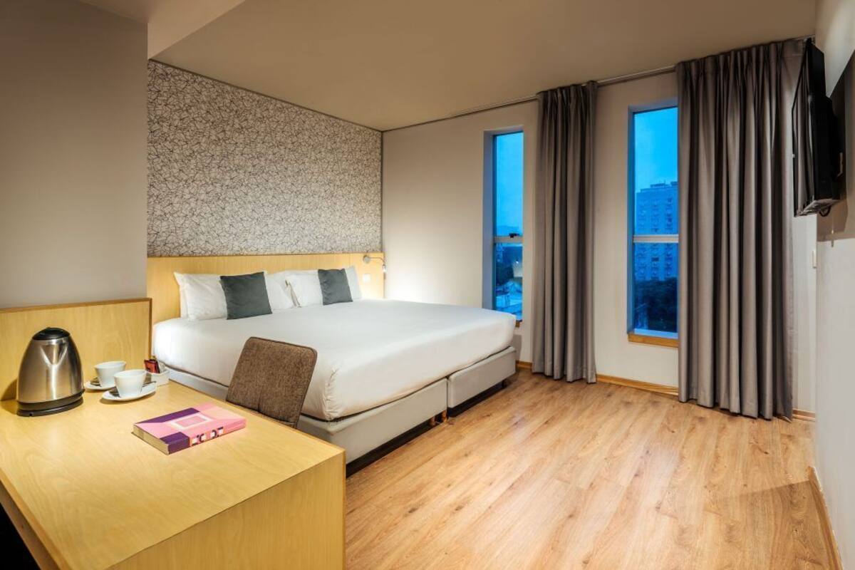 Standard Double Room | Minibar, in-room safe, desk, blackout drapes
