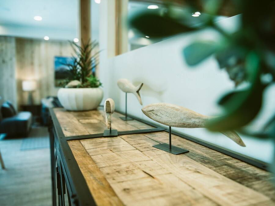 A wooden reception desk with a mounted sculpture of a bird.