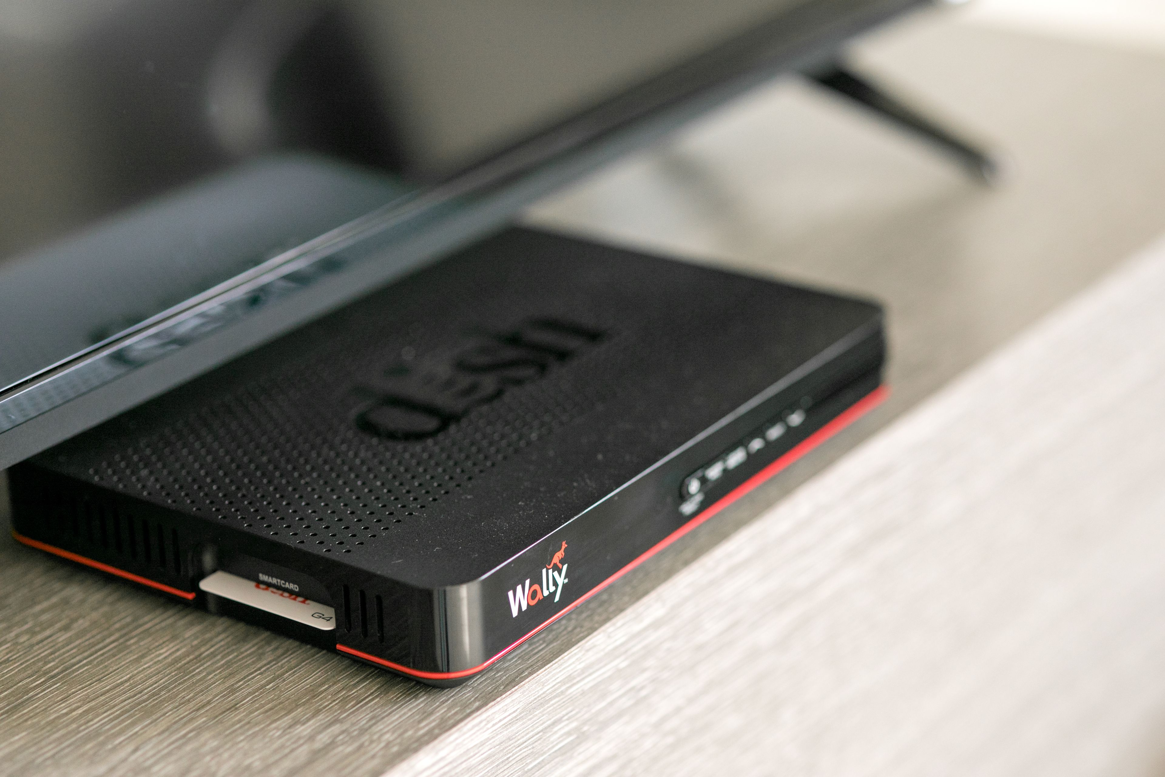 A black and red electronic device with a logo and text on its side.