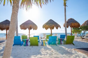 On the beach, white sand, free beach cabanas, sun loungers