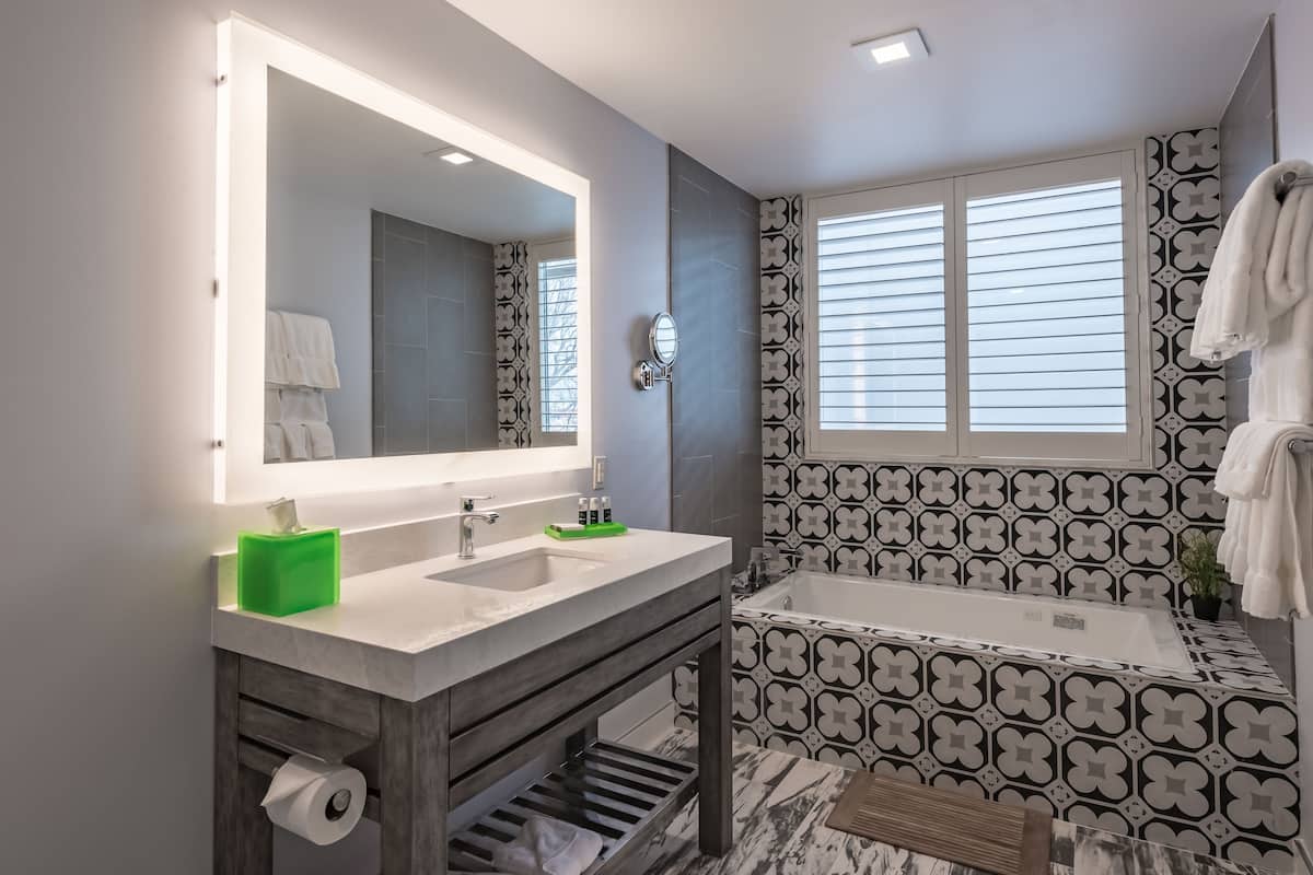 deluxe room, 2 queen beds, balcony | bathroom | eco-friendly toiletries, hair dryer, towels