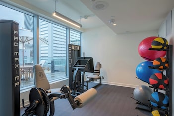 Work out with a city view at this gym featuring a leg press machine, seated row machine, and bench press. at The Laura Hotel, Houston Downtown, Autograph Collection