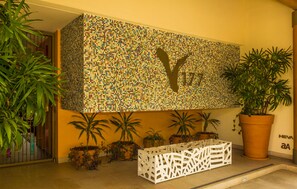 A mosaic wall with a silhouette, potted plants, and a white decorative bench. - V177 Condo at Vallarta Romantic Zone (Puerto Vallarta)