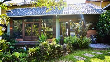 Enjoy a serene atmosphere in this charming home surrounded by lush greenery and an outdoor space.