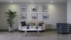 A modern living room with a sofa, coffee table, and a potted plant. - Lima Flats 2 (Lima)