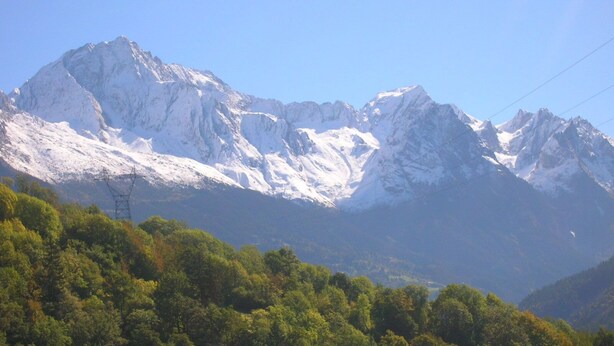 A mountainous landscape with snow-capped peaks and dense forest in the foreground. - SUPERB GITE 8 PEOPLE (Bozel)