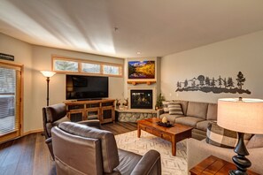 A living room with a fireplace, a television, and a sofa.