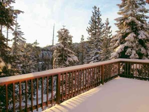 A snow-covered deck with a railing, surrounded by snow-laden trees. - Tahoe Mountain Retreat with Views Decks Hot Tub by Events Beaches Golf Heavenly (Stateline)