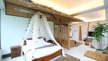 A modern bedroom with a canopy bed, a wooden headboard, a small bedside table, and a large potted plant.