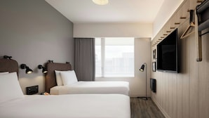 A hotel room with two beds, a large window, a flat-screen TV, and a wall-mounted coat rack. - Moxy Tokyo Kinshicho (Tokyo)