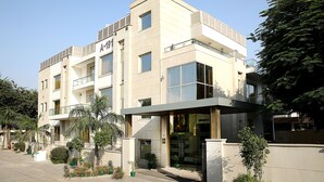 A modern building with multiple floors, large windows, and a flat roof.