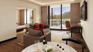 Luxury Studio Suite, 1 Queen Bed, Pool View | Living area | TV