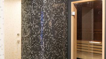 Bathroom features a mosaic tile wall, glass shower door, and a wooden bench.