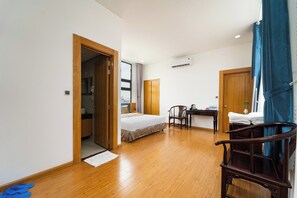 A hotel room with a bed, a desk, a chair, and a bathroom. - The Blue Hotel (Ho Chi Minh City)