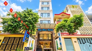 The Blue Hotel with a prominent entrance, a visible staircase, and a clear view of the surrounding buildings. - The Blue Hotel (Ho Chi Minh City)