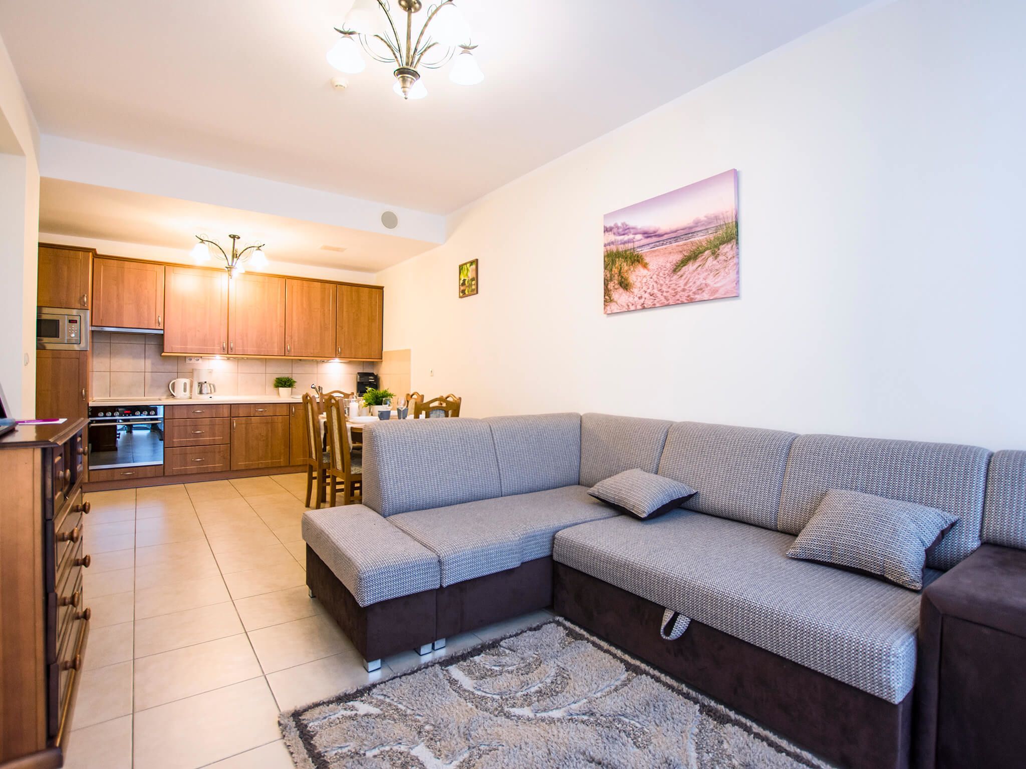 A modern apartment with a living area, kitchen, and dining space.