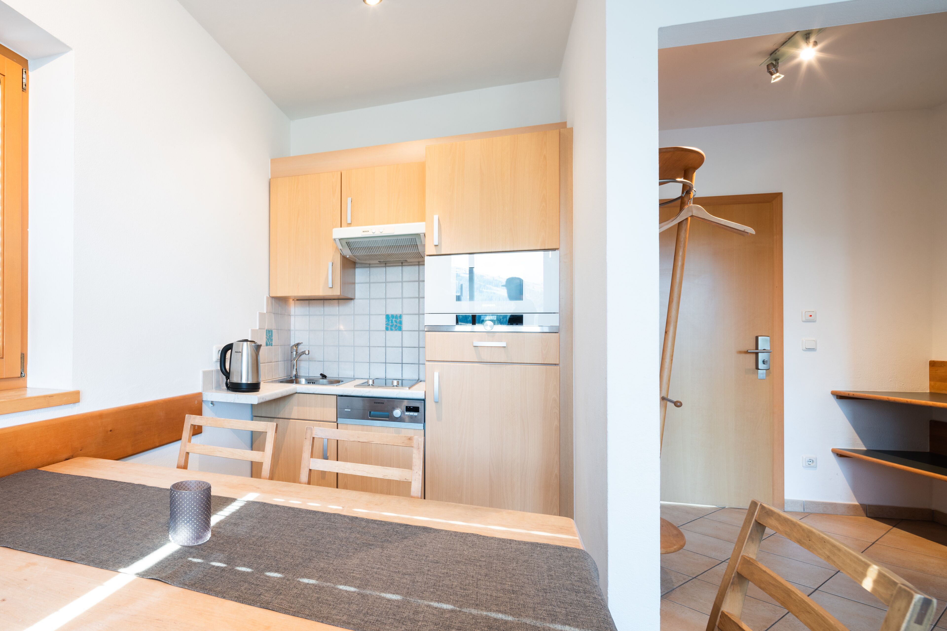 A modern kitchen with wooden cabinets, a countertop, and a built-in oven.