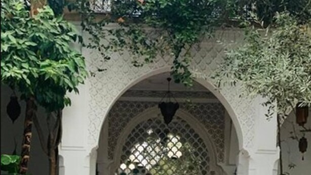 An indoor courtyard with a fountain, patterned floor, and an arched entrance. - Riad Ifoulki (Marrakech)