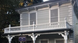 A two-story building with a balcony and a porch. There is a sign for 'Broad Street Inn' and a mailbox labeled 'Office'. - Broad Street Inn (Nevada City)