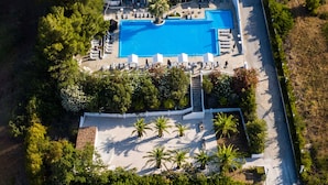An aerial view of a property with a swimming pool, tennis courts, and a landscaped garden. - Bianco Olympico Beach Resort By Anayia AI Resorts (Polygyros)