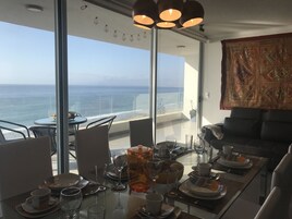 Deluxe Apartment, 2 Bedrooms, Ocean View, Beachside | Living area | 49-inch flat-screen TV with cable channels, Smart TV