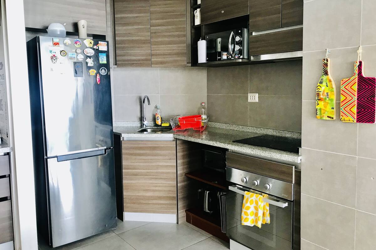 A modern kitchen with stainless steel appliances, a sink, and a stove.
