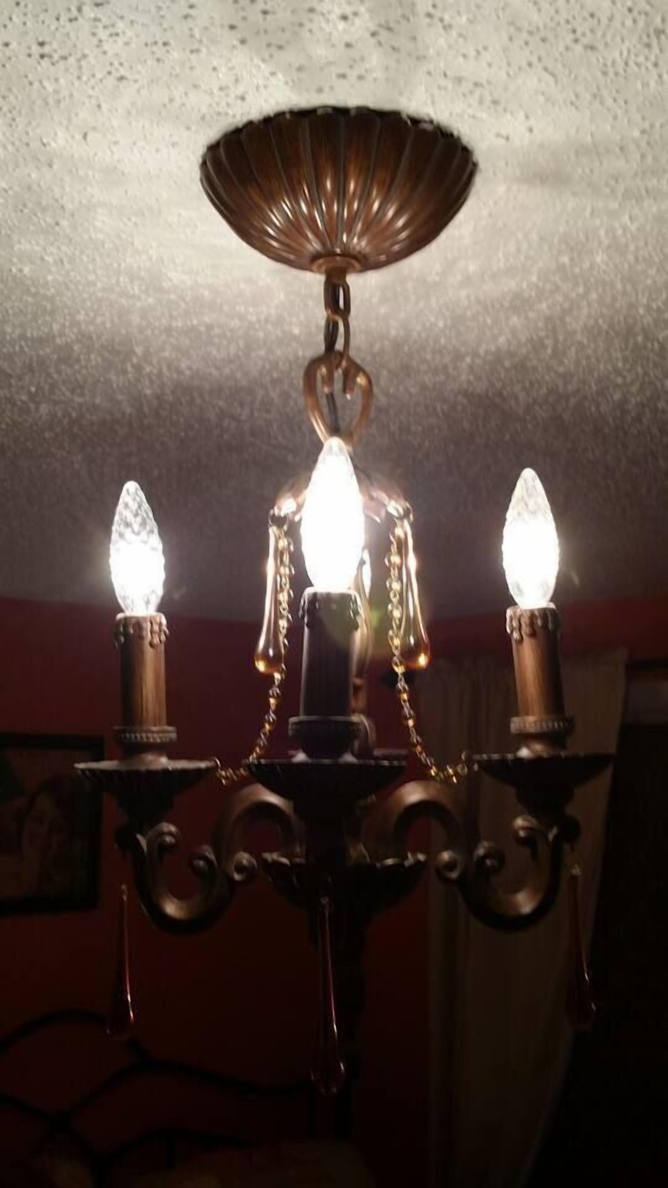 A chandelier with three light bulbs.