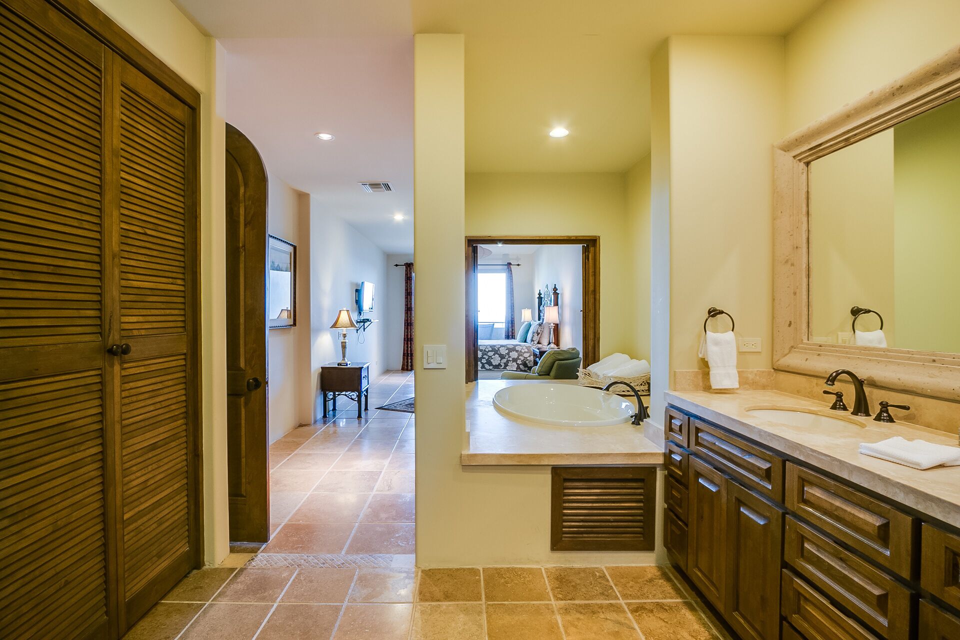 A modern bathroom with a large sink, vanity, and a mirror.