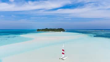 On the beach, white sand, sun-loungers, beach umbrellas