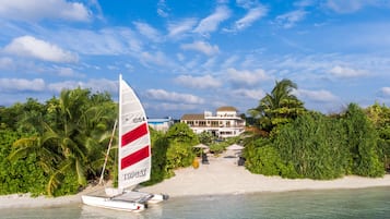 On the beach, white sand, sun-loungers, beach umbrellas