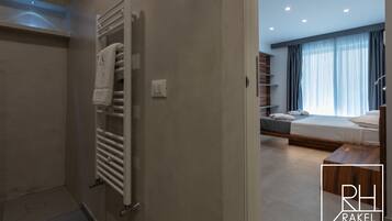 Ein modernes Badezimmer mit Handtuchhalter und einer sichtbaren Duschkabine.